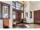 Welcoming foyer with hardwood floors, chandelier, and custom wood door with sidelights at 1279 Estates Dr, Breckenridge, CO 80424