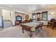 Spacious game room features a pool table, leather seating, and abundant natural light from the windows at 1279 Estates Dr, Breckenridge, CO 80424
