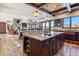 Open-concept kitchen with island, granite countertops, dark wood cabinetry, and living room view at 1279 Estates Dr, Breckenridge, CO 80424