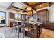 Gourmet kitchen with wood ceiling beams, granite countertops, breakfast bar seating, and custom wood cabinetry at 1279 Estates Dr, Breckenridge, CO 80424