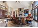 Cozy living room featuring a stone fireplace, leather furniture, and hardwood floors at 1279 Estates Dr, Breckenridge, CO 80424