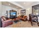 Comfortable living room featuring leather furniture, a flat-screen TV, and rustic decor, creating a cozy and inviting space at 1279 Estates Dr, Breckenridge, CO 80424