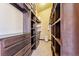 This walk-in closet offers ample storage space with custom shelves and dark wood drawers at 1279 Estates Dr, Breckenridge, CO 80424