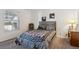 Bright bedroom featuring neutral paint, a wood headboard, and an ample closet at 6741 S Ivy Way # B4, Centennial, CO 80112