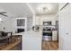 Well-equipped kitchen featuring stainless steel appliances and a breakfast bar, seamlessly connecting to the living area for easy entertaining at 6741 S Ivy Way # B4, Centennial, CO 80112