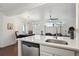 Bright kitchen featuring white countertops, stainless steel appliances, and views of living space at 6741 S Ivy Way # B4, Centennial, CO 80112