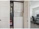 Conveniently located laundry closet with a stacked washer and dryer unit at 6741 S Ivy Way # B4, Centennial, CO 80112
