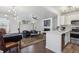 Bright living room with modern light fixtures, sleek ceiling fan and open floor plan to kitchen at 6741 S Ivy Way # B4, Centennial, CO 80112