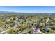 Scenic aerial view showing the property in a wooded neighborhood with mountain views in the distance at 7999 Centrebridge Dr, Niwot, CO 80503