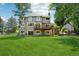 Expansive backyard featuring a large, well-maintained lawn, a deck, and mature trees for shade and privacy at 7999 Centrebridge Dr, Niwot, CO 80503