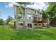 Spacious backyard featuring a deck, lush lawn, and mature trees, perfect for outdoor entertaining at 7999 Centrebridge Dr, Niwot, CO 80503