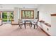 Charming basement seating area with a glass table and picturesque view of the outdoors at 7999 Centrebridge Dr, Niwot, CO 80503