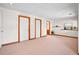 Finished basement with neutral flooring, complemented by wood trim and white paneled doors at 7999 Centrebridge Dr, Niwot, CO 80503