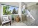 Bathroom features a large window with outdoor views, a comfortable chair and a tiled shower at 7999 Centrebridge Dr, Niwot, CO 80503