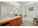 Bathroom features double sinks, wood cabinets, and a shower-tub combination at 7999 Centrebridge Dr, Niwot, CO 80503
