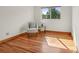 Bedroom with wood floors has a comfortable accent chair and a large window at 7999 Centrebridge Dr, Niwot, CO 80503