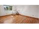 Bedroom with wood floors has a comfortable chair and a large window at 7999 Centrebridge Dr, Niwot, CO 80503