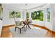 Elegant dining area with a chic table setting and windows that frame picturesque views of the lush outdoors at 7999 Centrebridge Dr, Niwot, CO 80503