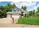 Inviting home with a two-car garage, lush lawn, and a charming walkway leading to the entrance at 7999 Centrebridge Dr, Niwot, CO 80503