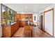 Beautiful kitchen featuring granite counters, stainless appliances, wood cabinets, tile floors, and island with seating at 7999 Centrebridge Dr, Niwot, CO 80503