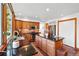 Modern kitchen featuring granite counters, stainless appliances, wood cabinets, tile floors, and an island at 7999 Centrebridge Dr, Niwot, CO 80503
