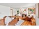 Relaxing living room boasts hardwood floors, fireplace, ample natural light, and cozy seating arrangements at 7999 Centrebridge Dr, Niwot, CO 80503