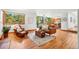 Comfortable living room featuring hardwood floors, natural lighting, a cozy seating area, and an open kitchen view at 7999 Centrebridge Dr, Niwot, CO 80503
