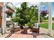 Cozy porch with comfortable seating, decorative flowers, and a serene view of the landscaped front yard at 7999 Centrebridge Dr, Niwot, CO 80503