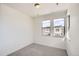 Bedroom featuring neutral carpet and two large windows with neighborhood views at 3157 S Russell St, Morrison, CO 80465