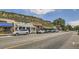 Street view of retail shops with cars parked along the side of the road at 3157 S Russell St, Morrison, CO 80465