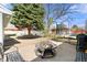A well-kept backyard includes a firepit, mature shade tree and trampoline at 6981 Zuni St, Denver, CO 80221