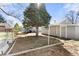 Spacious backyard featuring a large tree and detached garage, perfect for outdoor activities at 6981 Zuni St, Denver, CO 80221