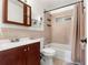 Well-lit bathroom features a vanity, toilet, shower, and tiled walls at 6981 Zuni St, Denver, CO 80221