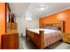 Well-furnished bedroom offers a wooden bed frame and a dresser with ample storage at 6981 Zuni St, Denver, CO 80221