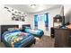 Cozy bedroom featuring two beds, carpet, and fun Mario Kart-themed decor at 6981 Zuni St, Denver, CO 80221
