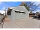 Detached garage with gray painted brick and concrete driveway at 6981 Zuni St, Denver, CO 80221