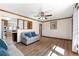 Cozy living room with hardwood floors, neutral walls, and comfortable seating at 6981 Zuni St, Denver, CO 80221