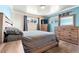 Comfortable main bedroom showcasing a large bed, two windows, and a dresser set at 6981 Zuni St, Denver, CO 80221