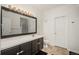 Well-lit bathroom with a large mirror, vanity, and toilet at 8707 E Florida Ave # 510, Denver, CO 80247