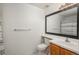 Functional bathroom with a single sink vanity and black framed mirror at 8707 E Florida Ave # 510, Denver, CO 80247
