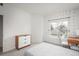 Bright bedroom with a three-drawer dresser and a large window with views of the outdoors at 8707 E Florida Ave # 510, Denver, CO 80247