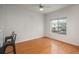 Bright bedroom with hardwood floors, a ceiling fan, and a large window with neighborhood views at 8707 E Florida Ave # 510, Denver, CO 80247