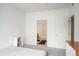 Clean bedroom with a view into an ensuite bath and a side bookshelf at 8707 E Florida Ave # 510, Denver, CO 80247