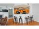 Open kitchen with wood cabinets, breakfast bar, and black appliances overlooking the living area at 8707 E Florida Ave # 510, Denver, CO 80247