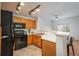 Well-lit kitchen showcasing oak cabinetry, black appliances, and an open layout design at 8707 E Florida Ave # 510, Denver, CO 80247