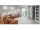 Bright living room featuring modern sofas, plush carpeting, and access to a private balcony at 8707 E Florida Ave # 510, Denver, CO 80247