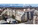 Beautiful multi-story condos with balconies, greenery, street view and the city skyline set against a backdrop of mountains at 2500 E Cherry Creek South Dr # 213, Denver, CO 80209