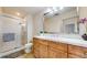 Bathroom features a tiled shower, bright lights, and a large sink at 2500 E Cherry Creek South Dr # 213, Denver, CO 80209