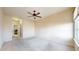 Spacious bedroom features neutral carpet, a ceiling fan, and a bright window at 2500 E Cherry Creek South Dr # 213, Denver, CO 80209