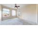 Sunlit bedroom featuring large windows, plush carpeting, and a modern ceiling fan at 2500 E Cherry Creek South Dr # 213, Denver, CO 80209